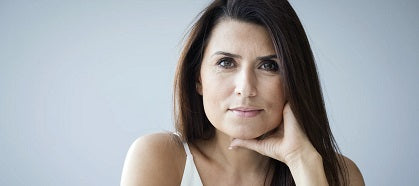 Middle-aged woman looks straight ahead