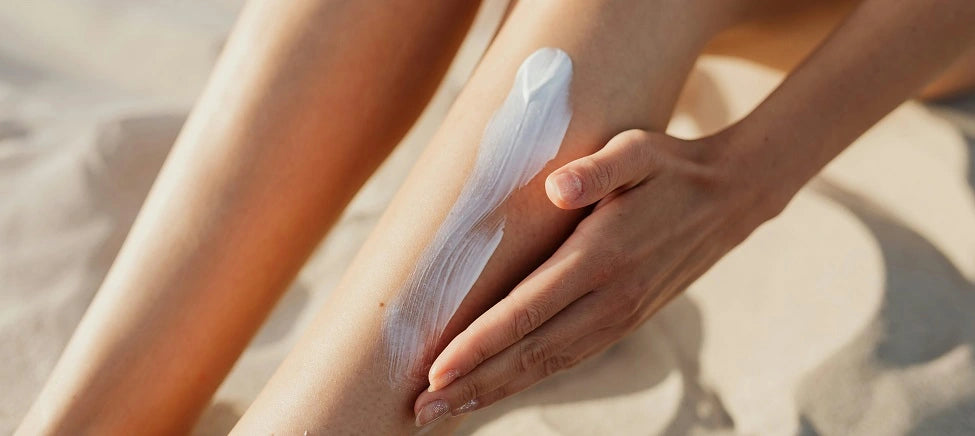 Woman applying sunscreen to legs