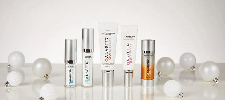 5 ALASTIN Skincare products surrounded by ornaments